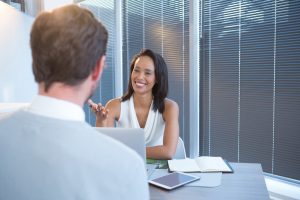 Business executives discussing at desk in office