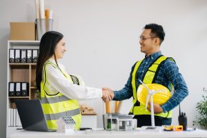 Engineer desk with object paper and tablet with blurry engineer teamwork hardworking to consults about their building project. in office
